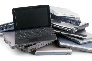 Stack of used laptops for recycle , white background
