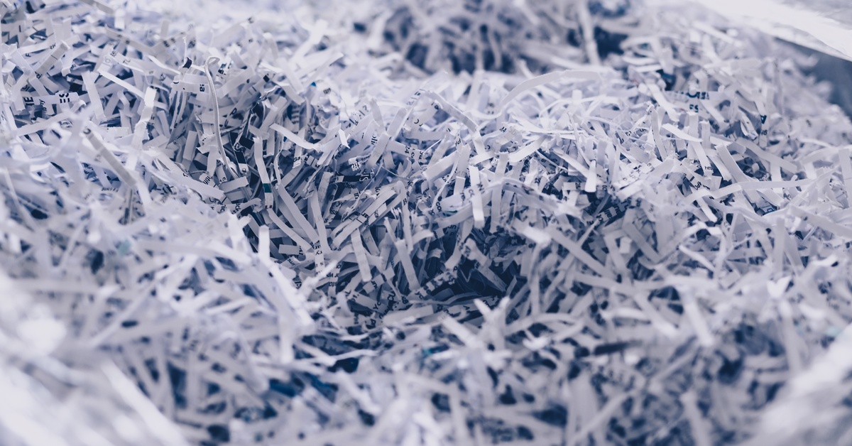 A large mass of shredded paper documents in one messy pile, with all text obscured by the extent of the shredded.