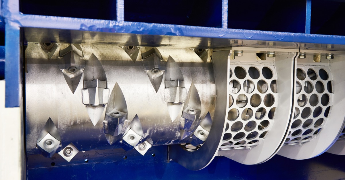 A rotor cutter used for industrial shredding. The exterior is blue and the interior is a metallic silver color.