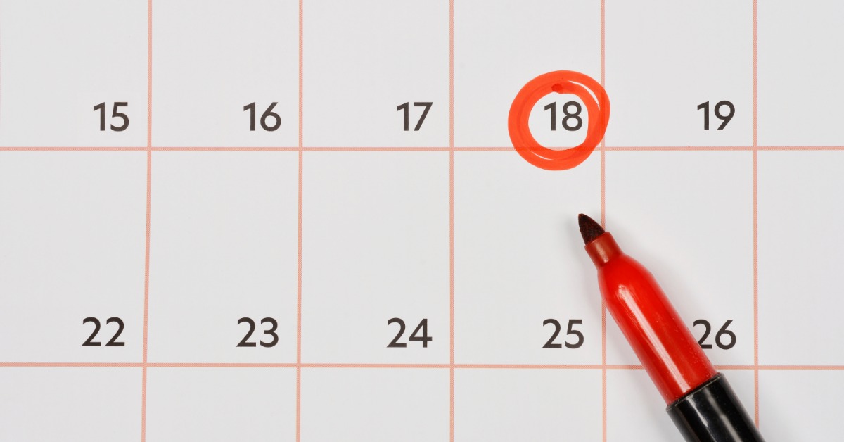 A calendar with large date cells. One date, the eighteenth, is circled using red marker to signify importance.