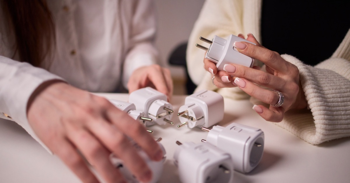 A pair of business professionals looking over leftover prototypes for a white electronic lighting component.